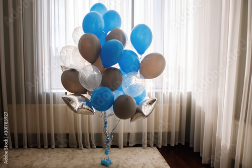 In the hotel room, balloons.