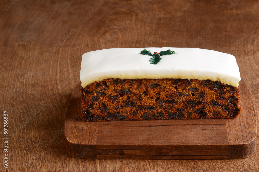 Fototapeta premium christmas fruitcake with holly decoration
