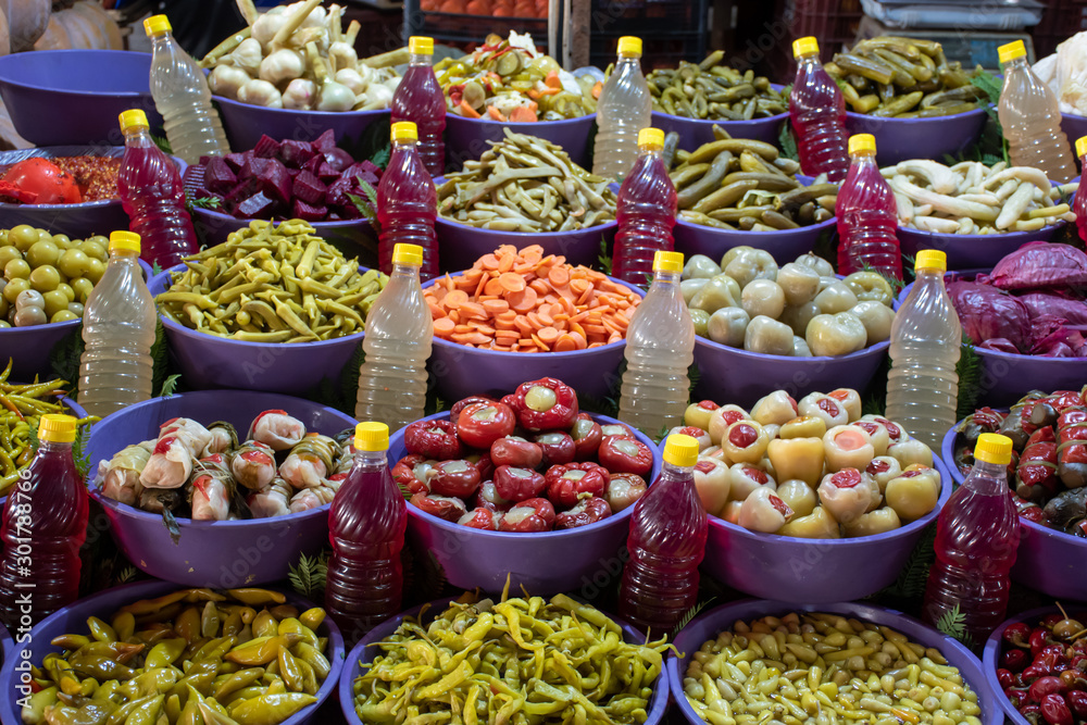 Mixed Pickles at food market selling by weight, green tomato, pepper, cucumber, garlic, plum and beet pickles