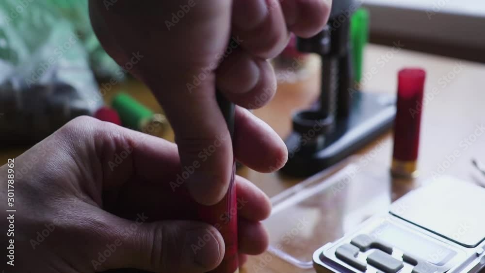 reloading process shotgun shells with special reload equipment. The hunter prepares for the hunt - he creates cartridges himself reloading process shotgun shells with special reload equipment. The hunter prepares for the hunt - he creates cartridges himself