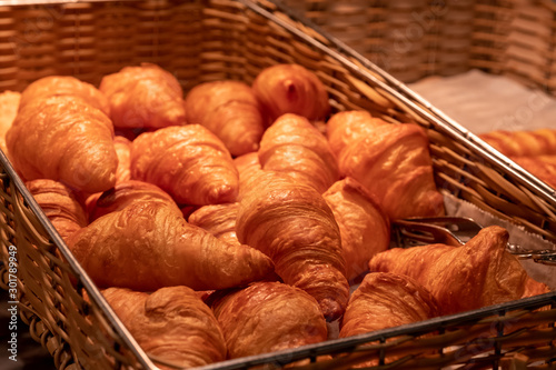 Close up croissants bakery in square bamboo basket © Sathaporn