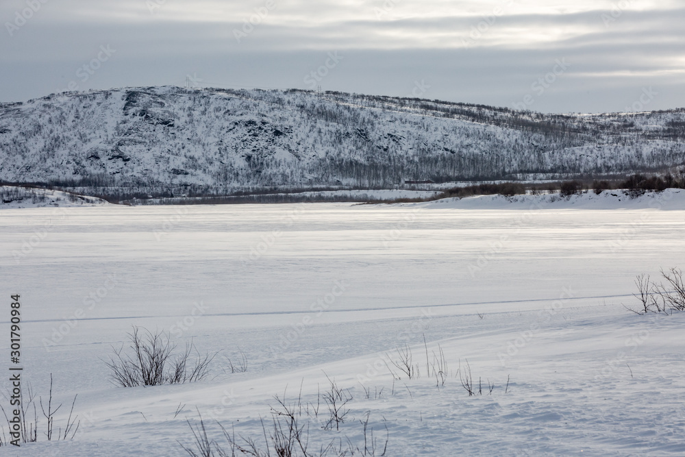 View on frosen river and montains, covered by snow. View on frosen river and montains, covered by snow.