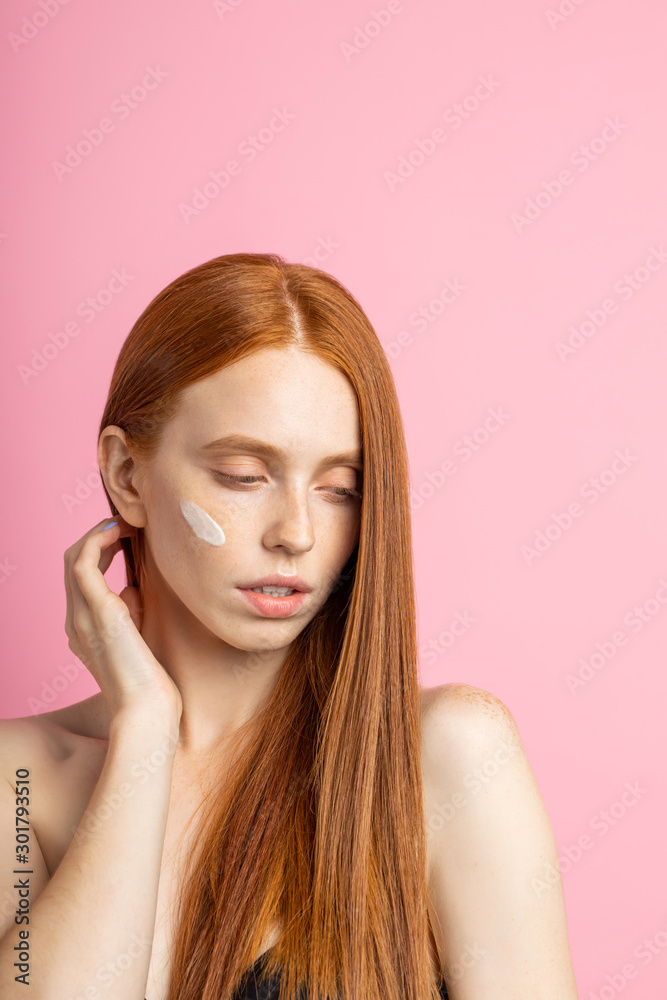 Beautiful young ginger woman with cream on face Beautiful young ginger woman with cream on face