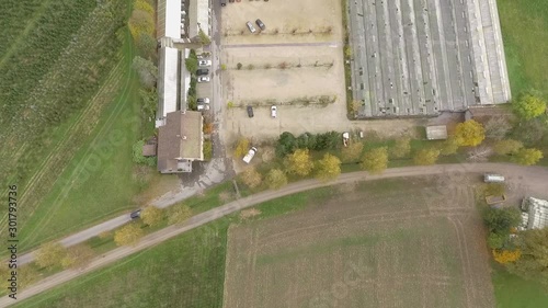 Aerial shot of a greenhouse in Uitikon, Switzerland and a car park adjacent to green fields. photo