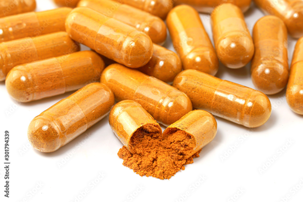 Turmeric (Curcuma longa L.) or Curcuma longa powder with capsule for alternative medicine isolated on white background, Spa products and food ingredient, Herb capsule. Turmeric (Curcuma longa L.) or Curcuma longa powder with capsule for alternative medicine isolated on white background, Spa products and food ingredient, Herb capsule.