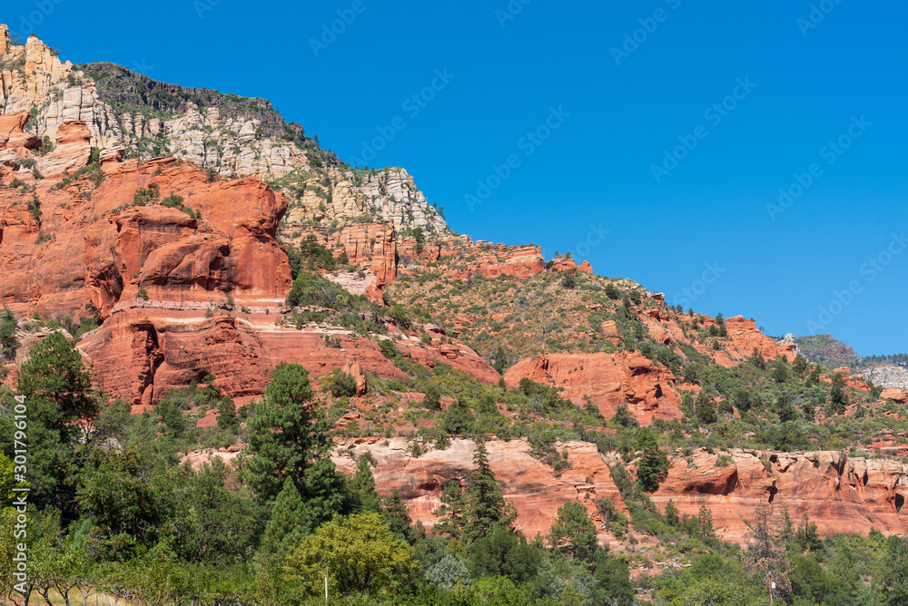 Low angle landscape of red and white rock formations at Slide Rock State Park in Arizona