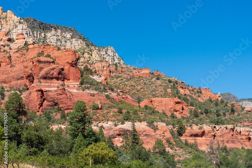 Low angle landscape of red and white rock formations at Slide Rock State Park in Arizona
