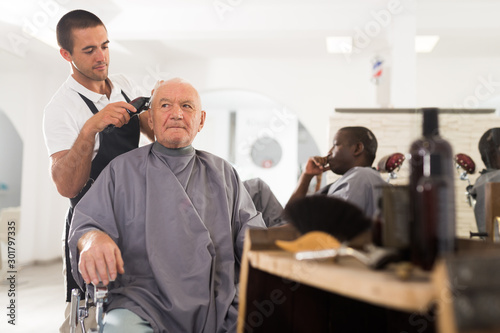 Elderly man getting haircut