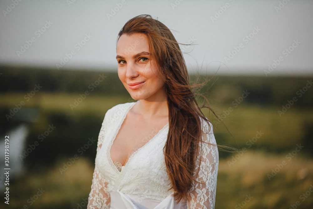 portrait of a young beautiful smiling woman in a white dress portrait of a young beautiful smiling woman in a white dress