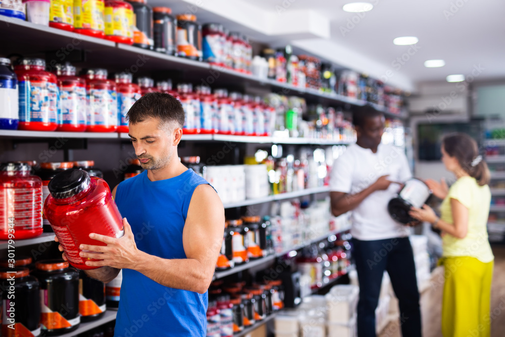 Man choosing food supplements in store