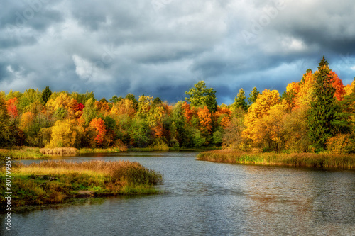 Beautiful autumn landscape with colorful trees by the river.