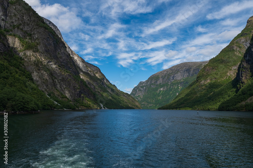 Mountains and Neroyfjord Sognefjord in Norway. Clouds and blue sky. July 2019