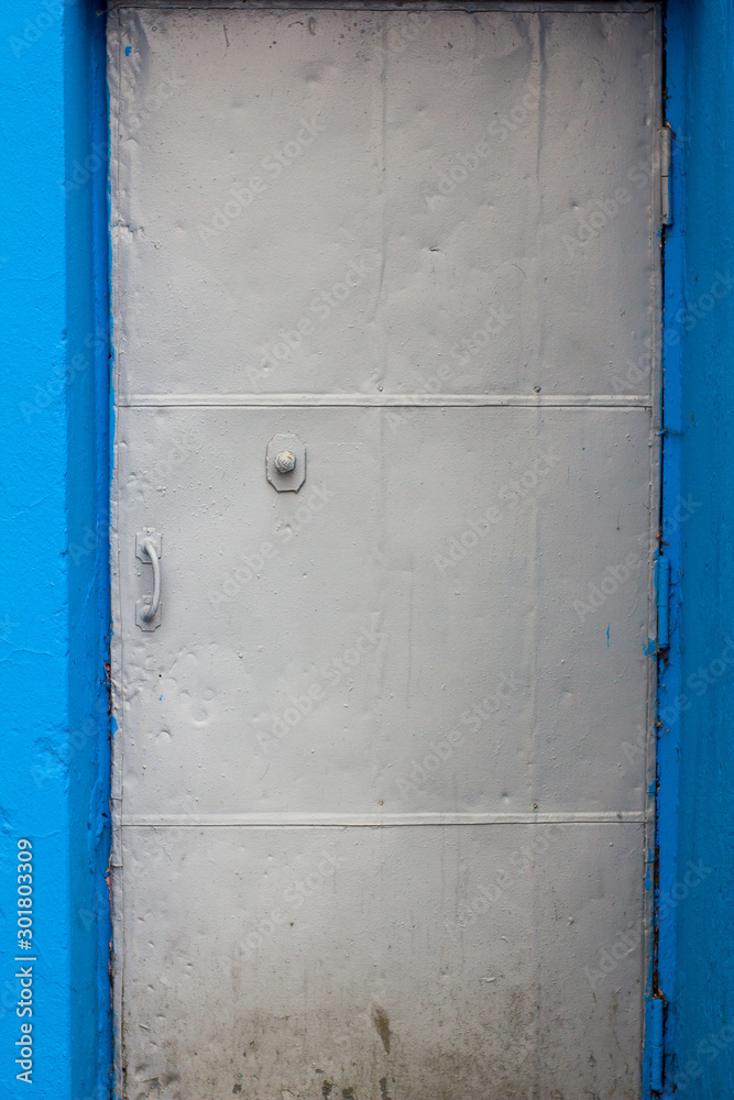 metal gray door in a blue opening metal gray door in a blue opening
