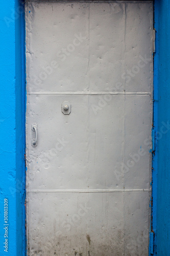 metal gray door in a blue opening