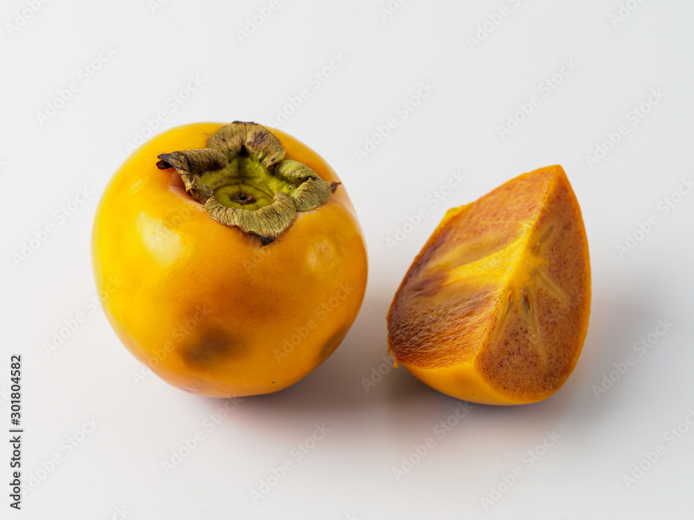 Single persimmon isolated on white background. Single persimmon isolated on white background.