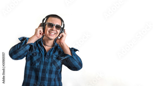 Young with headphones on white background, isolated. People, music, lifestyle. Digital lifestyle concept. Phone earphones. Wireless technology. Entertainment concept.