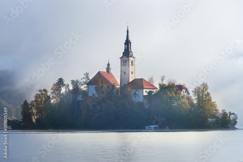 The Pilgrimage Church of the Assumption of Maria on lake Bled on a foggy hazy morning