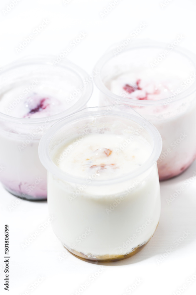 assortment of yogurts with fruit additives, vertical top view assortment of yogurts with fruit additives, vertical top view