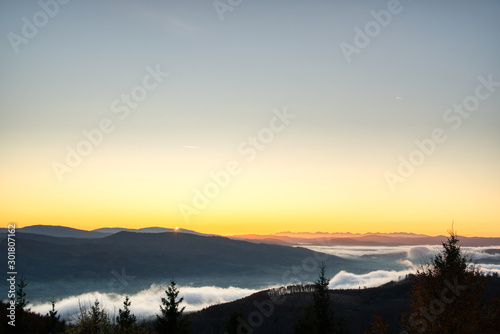 sunrise over mountains with fog in valley