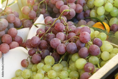 bunches of grapes on display on a market stall