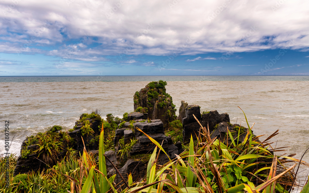 like a ship's bow shaped rock top at the Pacific Ocean