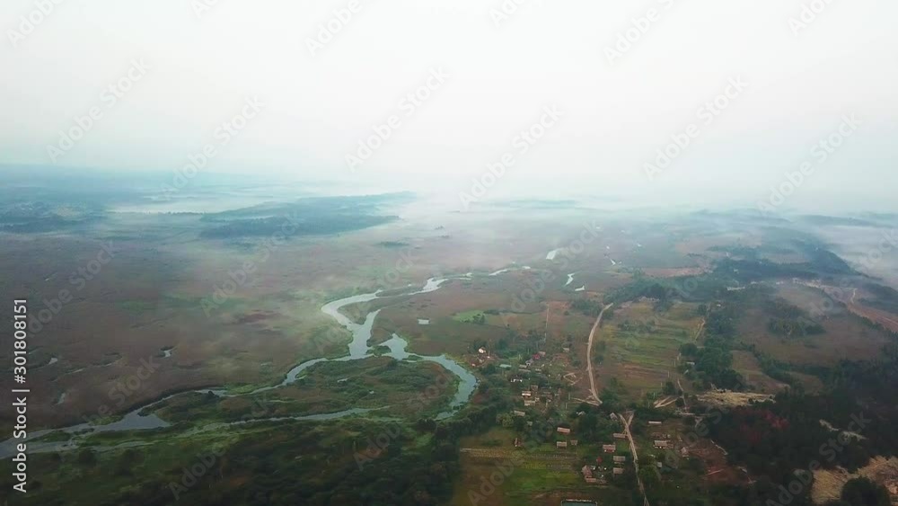 aerial view of village by the lake in the morning mist, aerial view of lake at sunrise, fog and sun over rivers, aerial view of fog over the marsh at dawn aerial view of village by the lake in the morning mist, aerial view of lake at sunrise, fog and sun over rivers, aerial view of fog over the marsh at dawn
