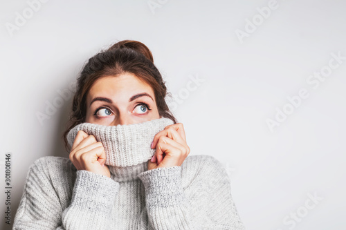 Portrait of a happy young woman in warm cozy sweater.