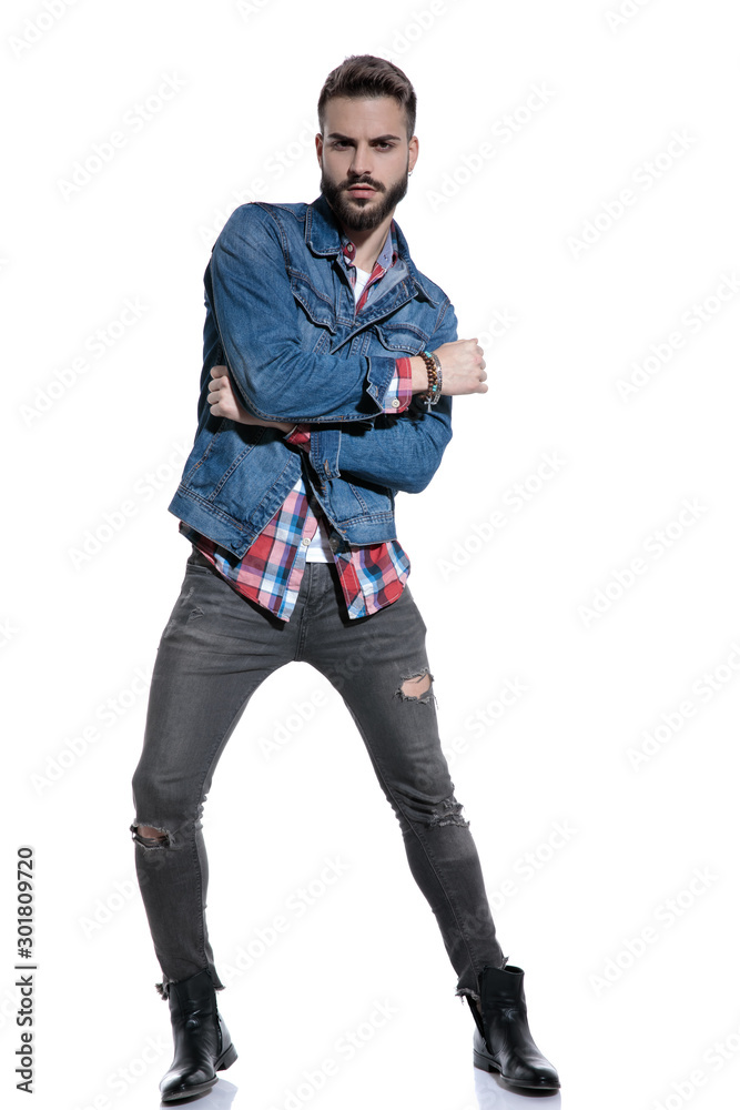 cool fashion guy posing and holding elbow in a fashion pose cool fashion guy posing and holding elbow in a fashion pose