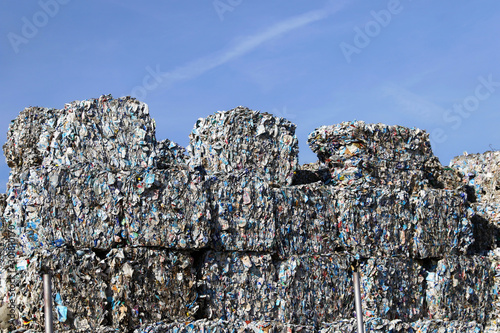 Plastic and paper bales at the waste processing plant. Separate garbage collection. Recycling and storage of waste for further disposal. Business for sorting and processing of waste. photo