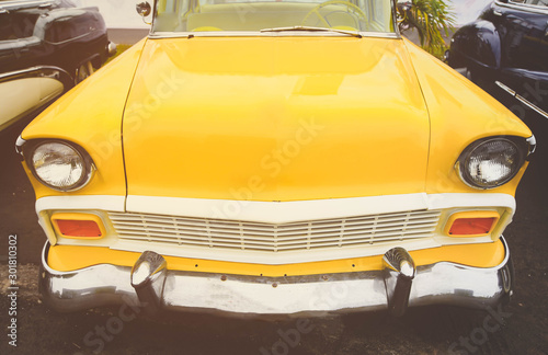 close up front yellow retro car parking outside