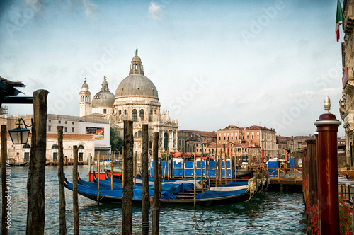 Fototapeta Naklejka Na Ścianę i Meble -  Docked Gondolas in Venice, Italy Grand Canal with domed church in background