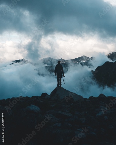 silhouette of man on top of mountain