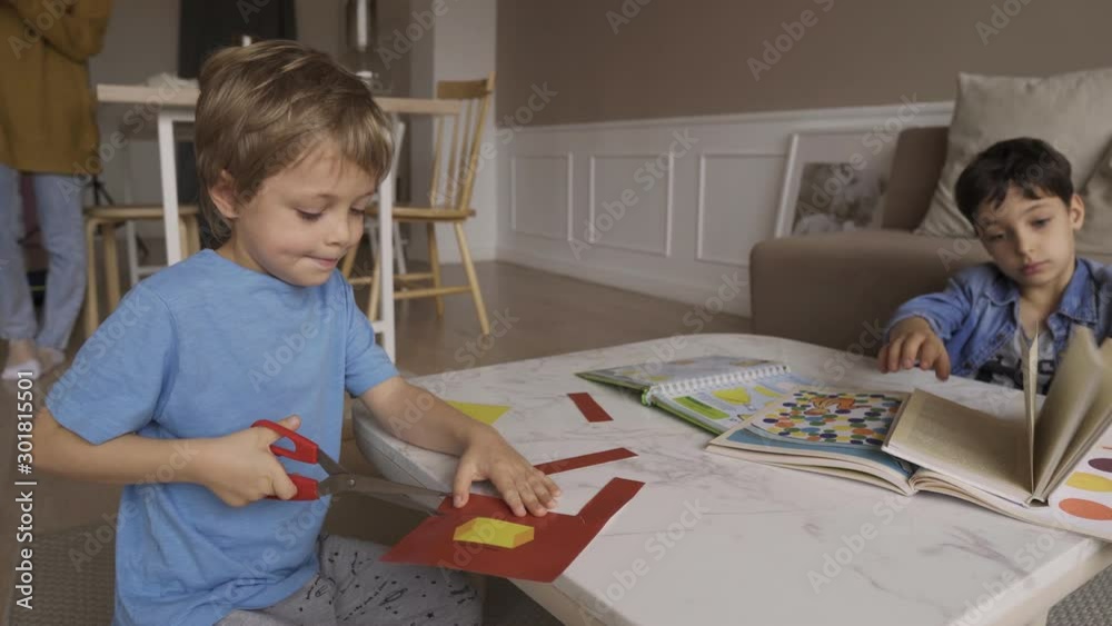 Concentrated 5 years boy cut paper with scissors passionately. Sticks out tongue. Concentrated 5 years boy cuts paper with scissors very passionately. He sticks. Concentrated 5 years boy cut paper with scissors passionately. Sticks out tongue. Concentrated 5 years boy cuts paper with scissors very passionately. He sticks.