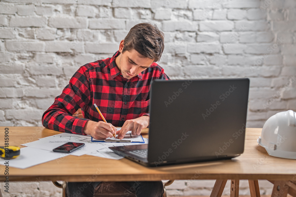 civil engineer at his Desk working with documents civil engineer at his Desk working with documents