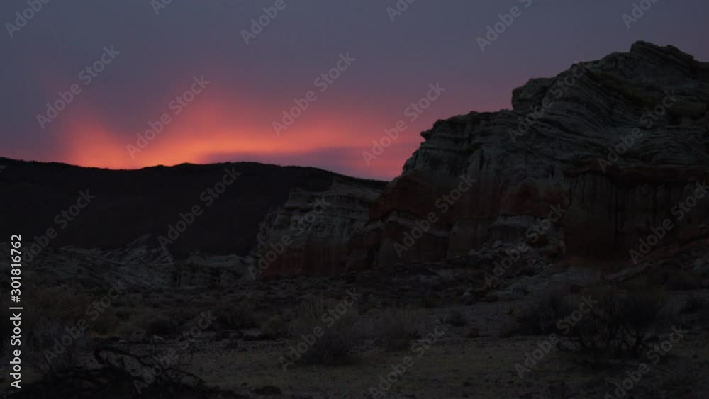 Sunset in Red Rock Canyon California.  Cinematic Silhouette Low Light with Red and Orange Sky.  Pan Left to Right