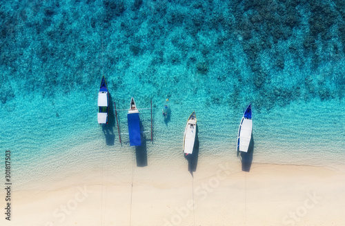 Boats on the water surface from top view. Azure water background from top vie...