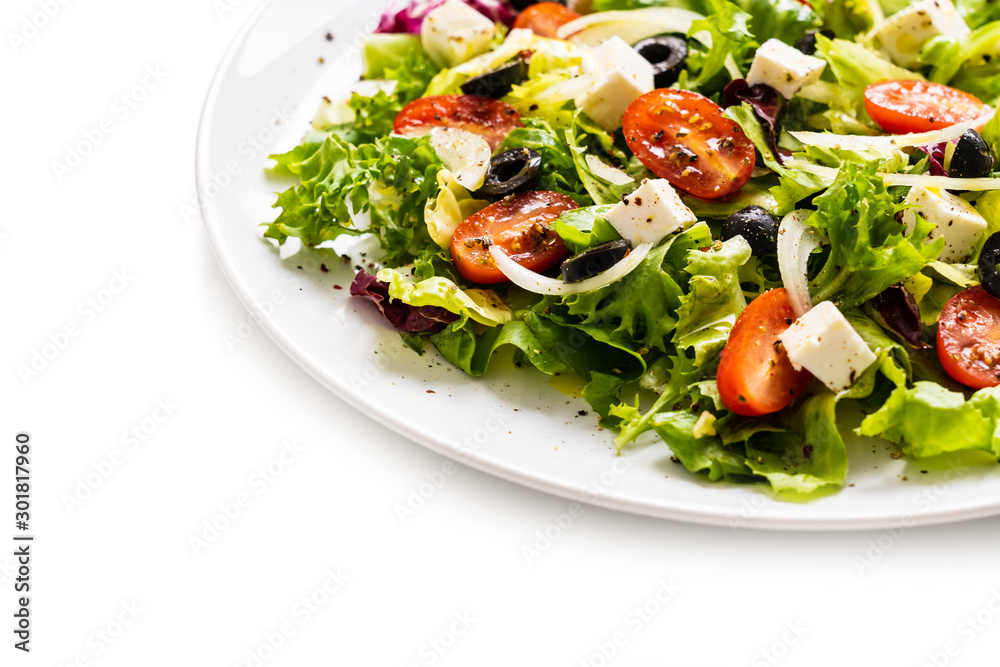 Fresh greek salad on a plate on white background Fresh greek salad on a plate on white background