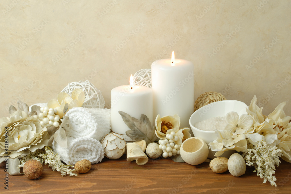 spa concept of white burning candles arranged with natural potpourri elements and flowers with bath slats on a warm background spa concept of white burning candles arranged with natural potpourri elements and flowers with bath slats on a warm background