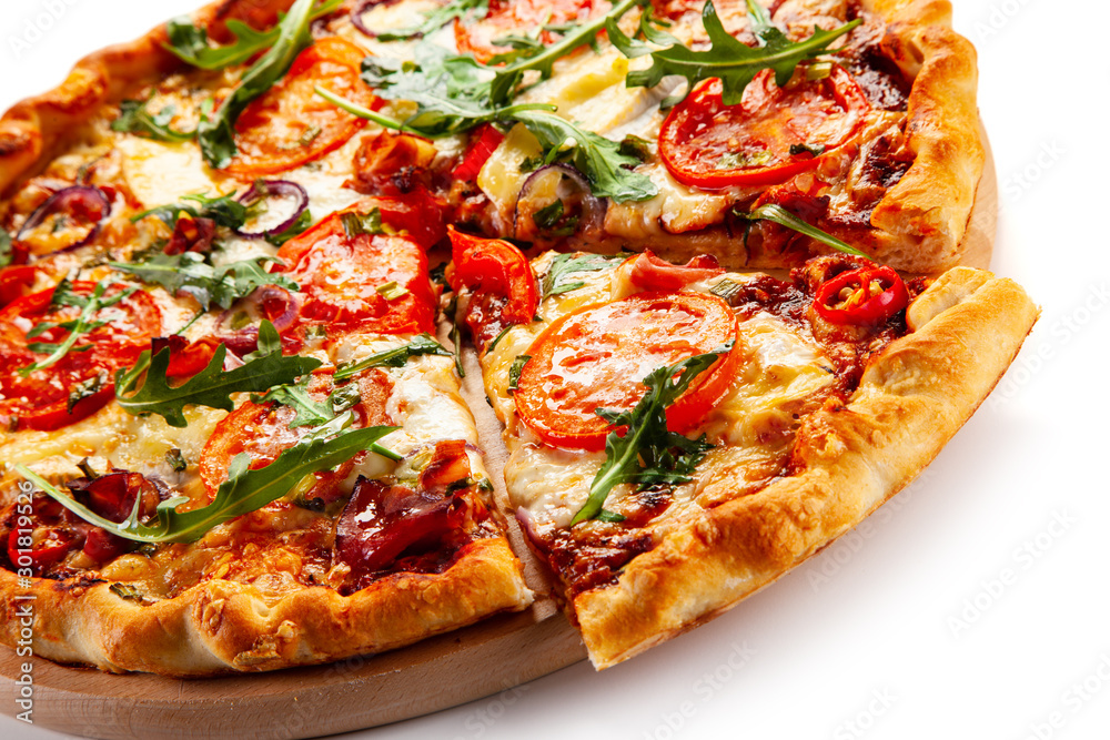 Pizza with ham, rucola, and vegetables on white background