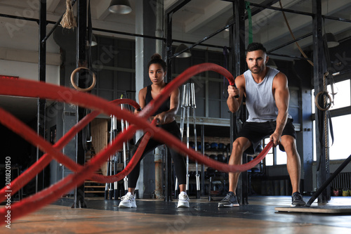 Aanklager Perth Blackborough Ingenieurs Washable wall murals Athletic young couple with battle rope doing exercise  in functional training fitness gym. - Nikkel-Art.com