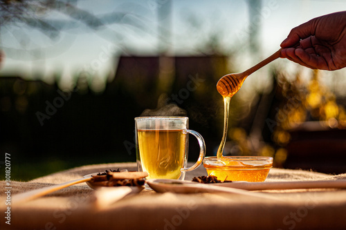 hot tea and honey in teacup outdoor