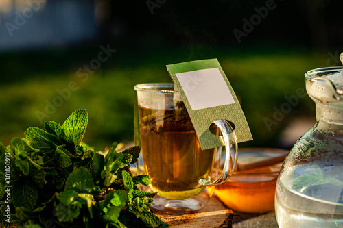 hot tea and honey in teacup outdoor © J.Pliacushok