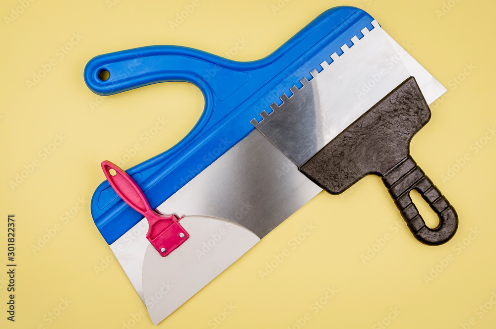 Spatula for different works on a yellow background. Spatula for different works on a yellow background.