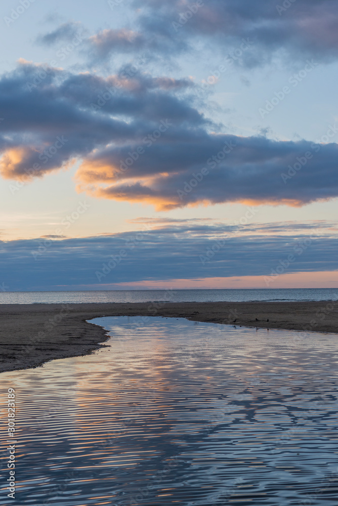 Obraz premium evening sky over the beach, the river anapka flowing into the black sea. Anapa, Krasnodar Krai, Russia.
