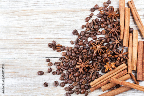 Star anise, cinnamon and roasted coffee beans. Aromatic spices on wooden background. Top view. Close up. Seasoning ingredients for cooking or baking