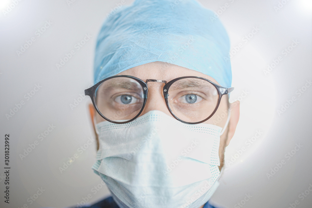 bottom view of a young surgeon looking at camera. Surgical operation in the hospital.