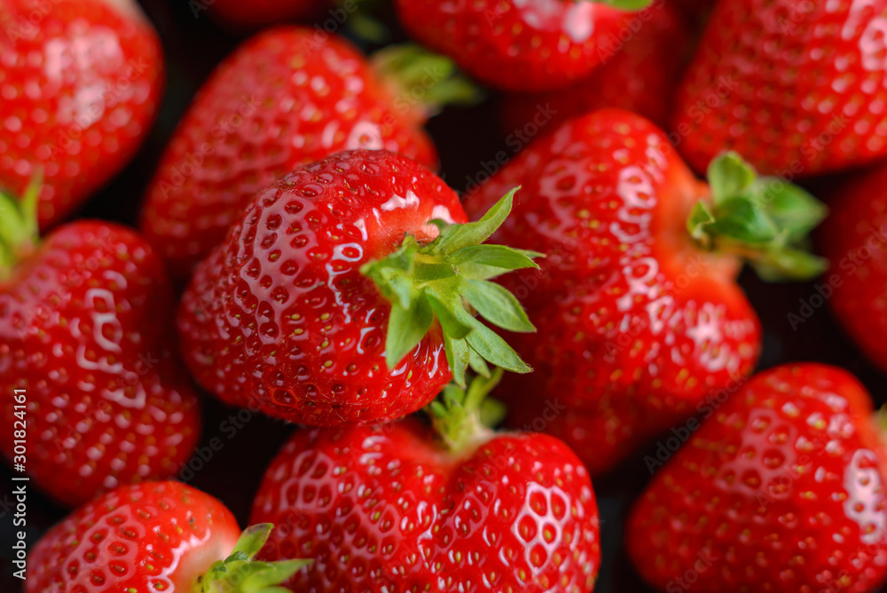 Strawberry closeup. Macro image of fresh strawberries on dark background Strawberry closeup. Macro image of fresh strawberries on dark background