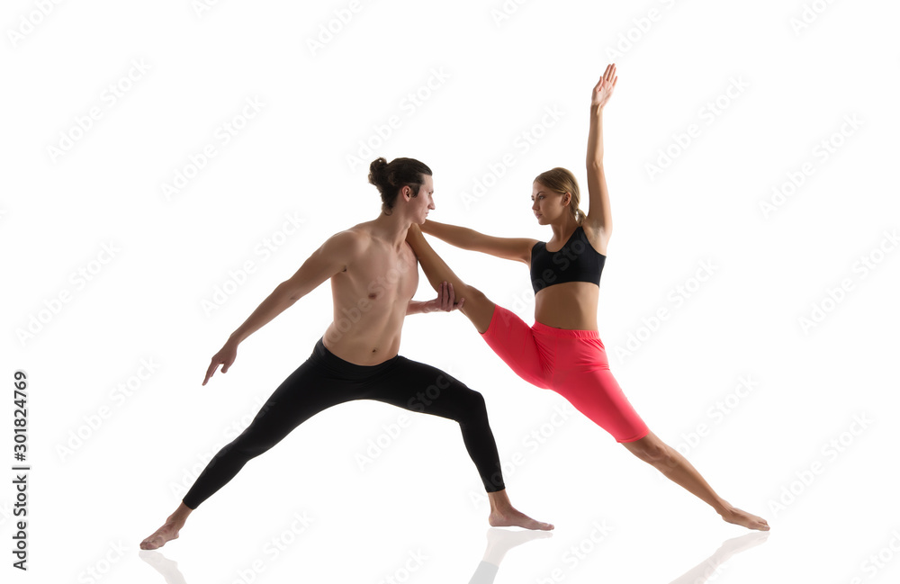 Overall fitness. Couple of athletes isolated on white. Athletic man and woman perform pilates workout. Full body athletic class. Sexy sportsman and sportswoman. Athletic training. Athletic and strong