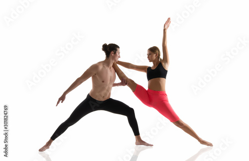 Overall fitness. Couple of athletes isolated on white. Athletic man and woman perform pilates workout. Full body athletic class. Sexy sportsman and sportswoman. Athletic training. Athletic and strong © be free