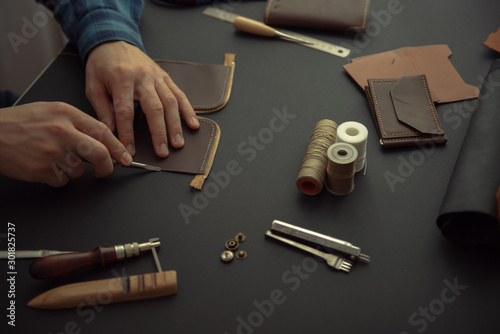 leather wallets on a black background with space for an inscription. Leather craft concept.